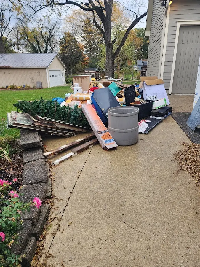 Dumpster being loaded with debris for 10 Yard Dumpster Rental in Monroe